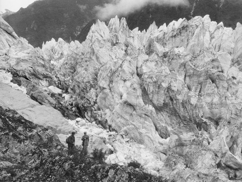 Two men next to craggy ice