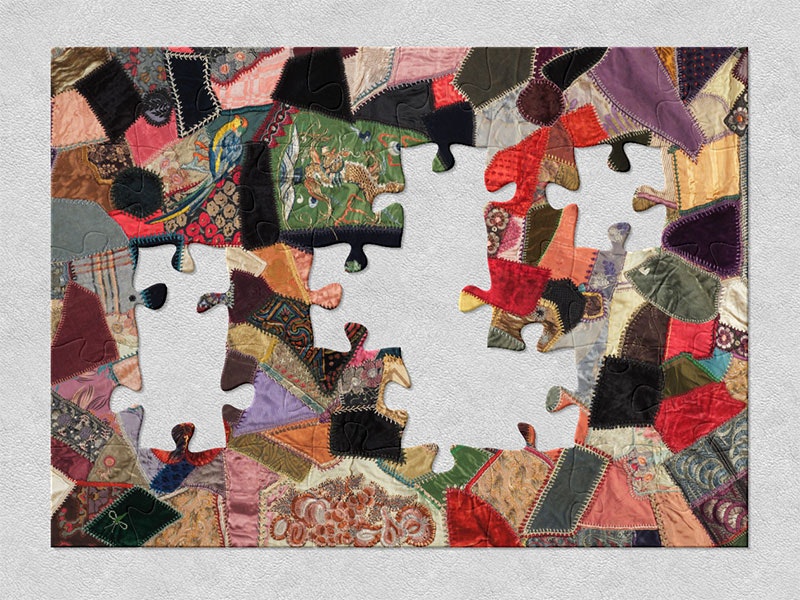 1920s crazy patchwork quilt created using a wide variety of textiles which reflect the diversity of textiles used in fashion at this time