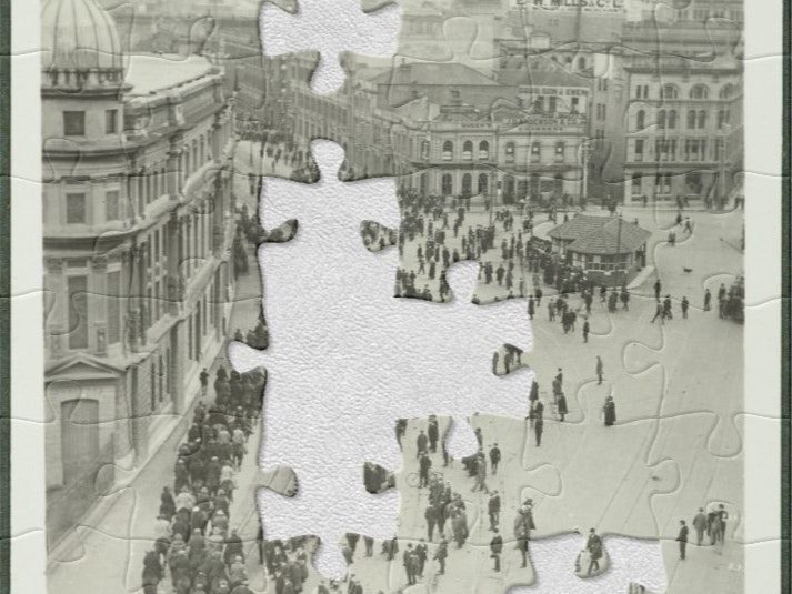 Wellington Harbour, during 1913 "Strike". From the album: Wellington waterfront strike, 1913, 1913, New Zealand, by Zak (Joseph Zachariah). Te Papa (O.030463) Black and white photo of people on horses and people standing in a row on a wide street with buildings in the background