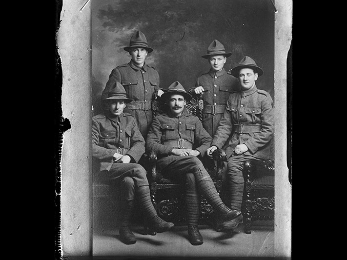 Copy of a portrait of five unidentified soldiers, inscribed Sturmer, 1916-1920, Wellington, by Berry & Co. Purchased 1998 with New Zealand Lottery Grants Board funds. Te Papa (B.047285) Five soldiers in a photographic studio. Three are sitting in a chair the others are standing.