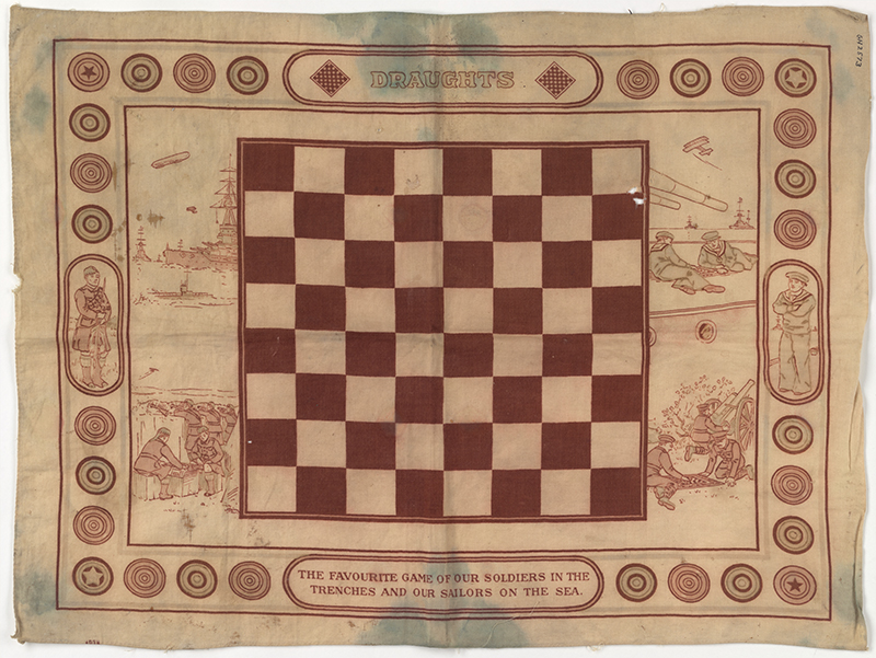 A draughts board on a piece of material. There is text on it referring to soldiers serving overseas.