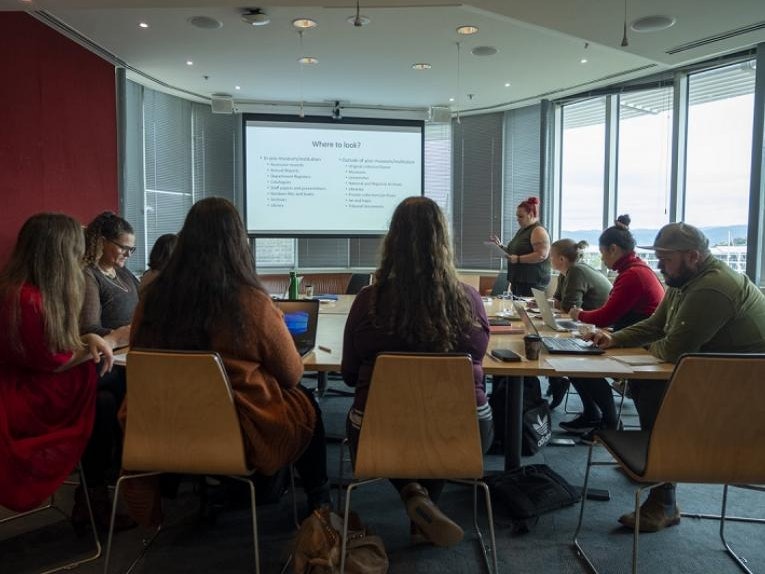 The Repatriation Networks meets regularly to share knowledge and expertise. National Services Te Paerangi repatriation workshop, 31 Mar 2021. Photo by Daniel Crichton-Rouse. Te Papa (168645) People gathered in a seminar room with someone talking at the front.
