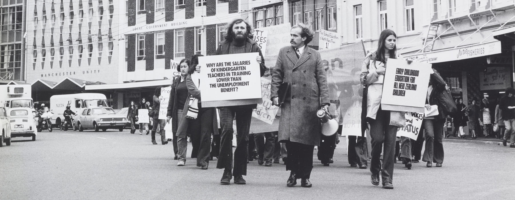 Black and white photo of protestors marching down a major road in Wellington’s city centre