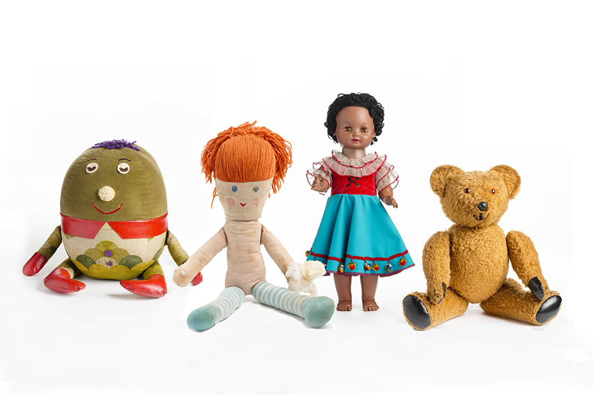 Four stuffed toys sitting or standing on a white background