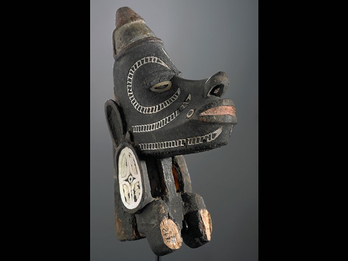 Nguzunguzu (War canoe prow figurehead), maker unknown, Solomon Islands. Te Papa (FE002431) A carved wooden head figurine with inlaid shells