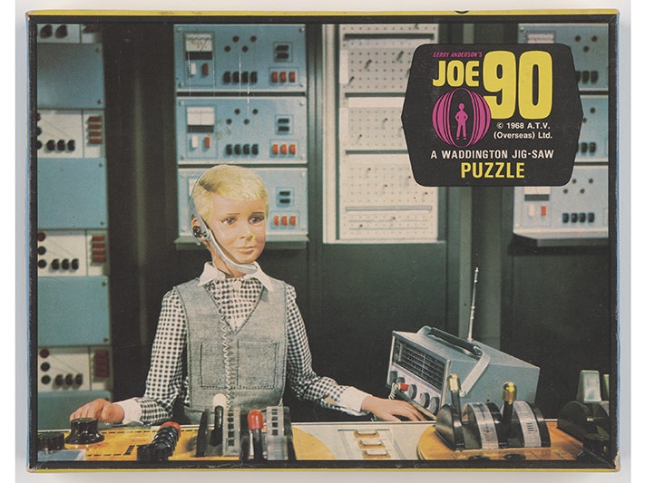 Jigsaw puzzle, Joe 90, Waddingtons; creating agency; 1960s. Purchased 2020. Used with permission. Te Papa (GH025914) A photo of the top of a jigsaw puzzle box with an image from the TV series Joe 90 on it.