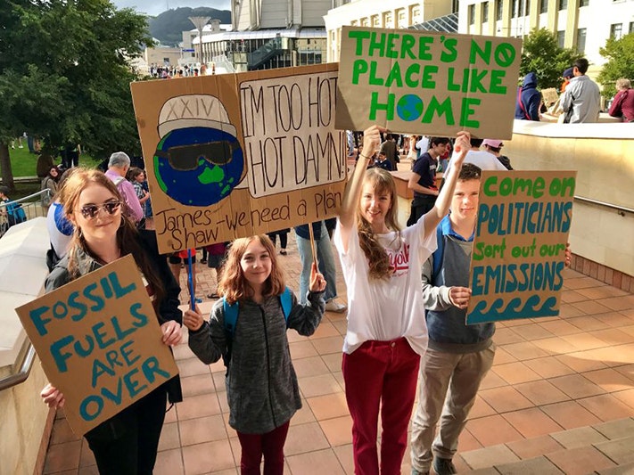 Students with their School Strike for Climate Action placards, Wellington. Photo by Raewyn Humphries; photographer; 15 March 2019; New Zealand. Gift of Raewyn Humphries, 2019. Te Papa (O.048375) Four school children holding protest signs outside in a public square.