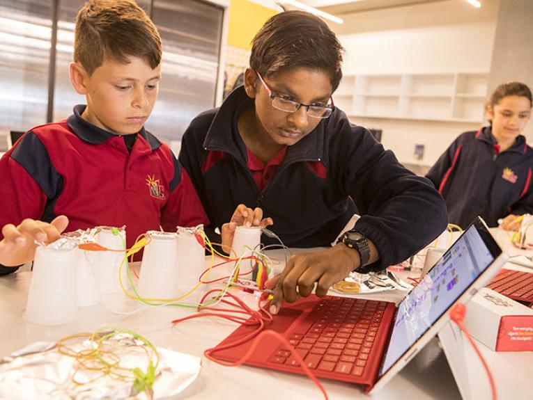 Students play with a computer