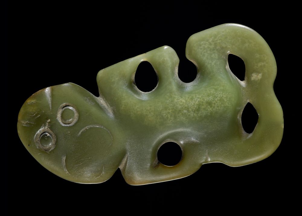 A pounamu or greenstone pendant in human form.