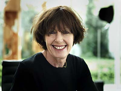 Head and shoulders photo of a woman with short dark hair. She is smiling at the camera.