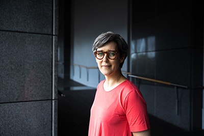 A head and shoulders of a woman with short hair.