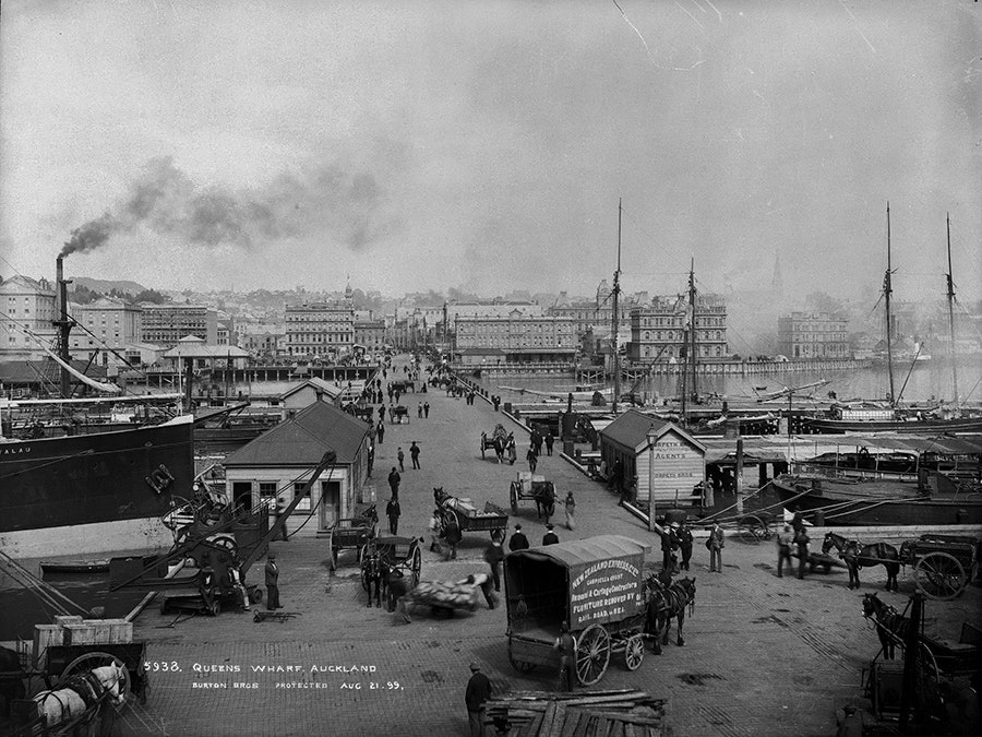 Queens Wharf, Auckland, 1890s, Dunedin, by Burton Brothers studio. Te Papa (C.011229) A black and white photo of an industrial active port in a city in the late 1800s.