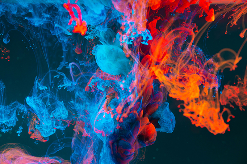 Blue, red, and orange swirly smoke on a black background.