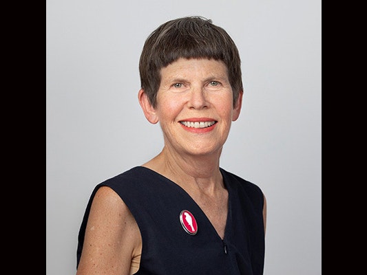 Sarah Hillary Head and shoulders of a woman with short hair.