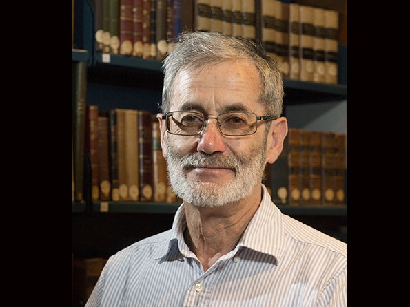 Michael Fitzgerald Head and shoulders of a man with a trim beard and glasses smiling sat the camera