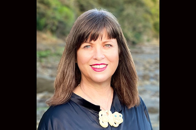 Head and shoulders photo of a woman with long brown hair.