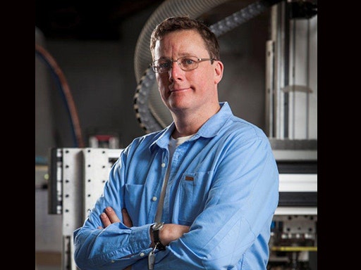 Richard Taylor A man in a blue shirt with his arms crossed is looking at the camera.