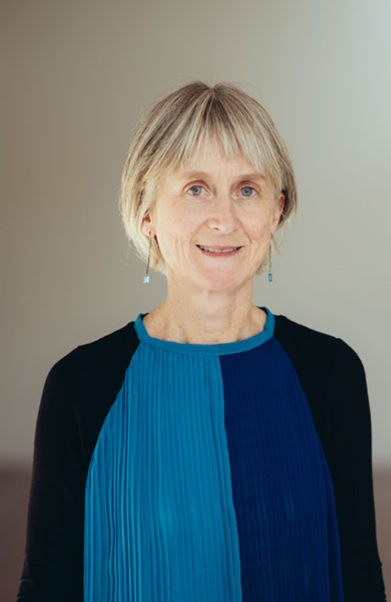 a woman with short hair is smiling at the camera