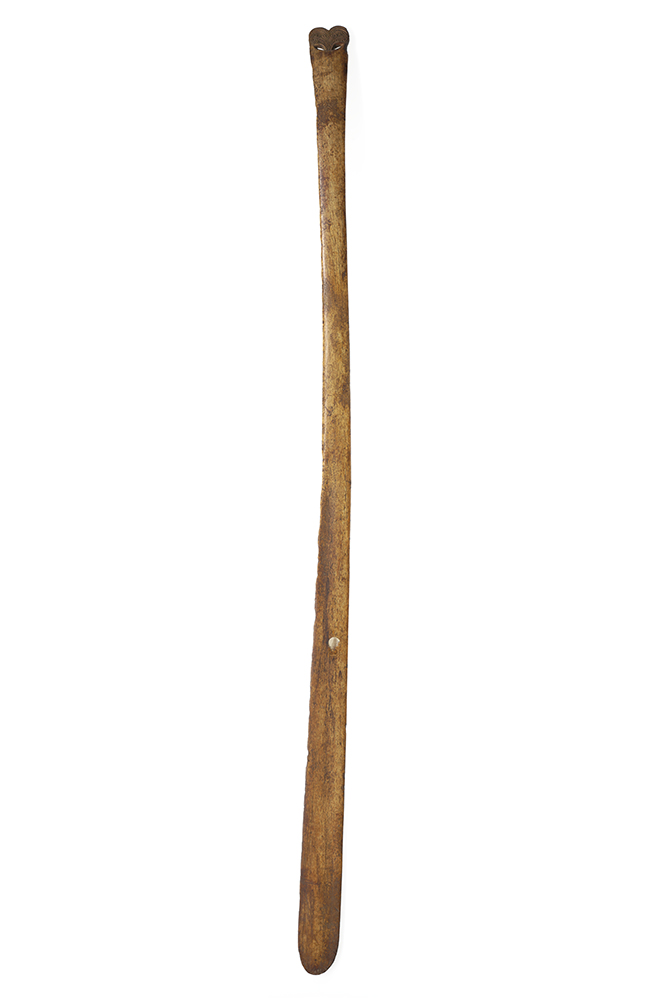 A long staff with a carved end made of whale bone