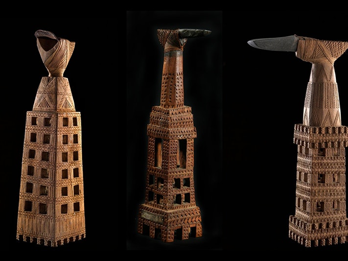 Ruatangaeo (ceremonial adze) Mangaia. Te Papa (FE002314, FE007277, FE002306) Three adzes with intricately carved wooden mounts on a black background.