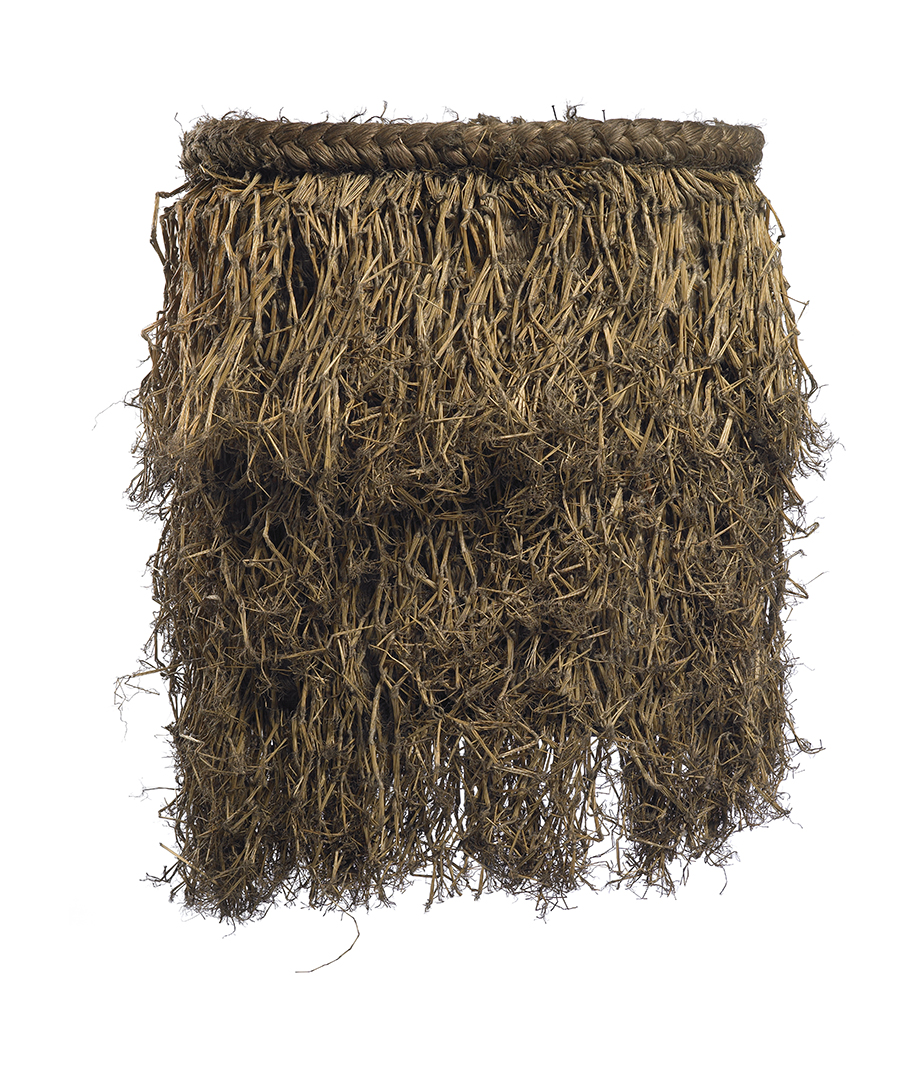 A rain cape that is made from many pieces of flax in three layers.