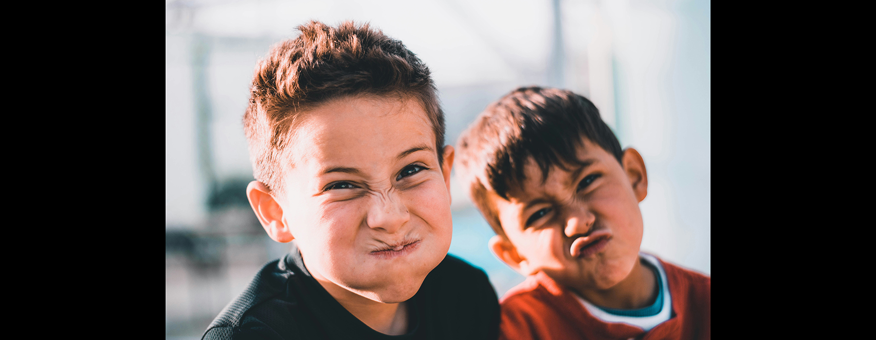 Close up of two children making faces at the camera.