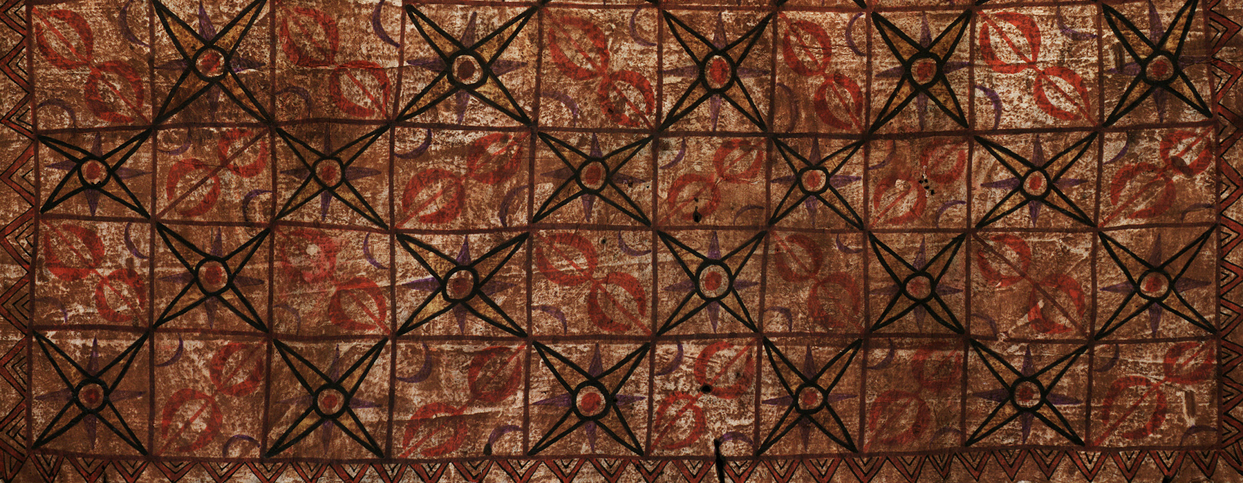 Tapa cloth with repeating patterns in red and black.