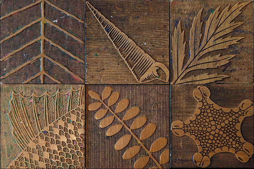 Six stamp blocks with different leaf, shell, and starfish patterns on them.