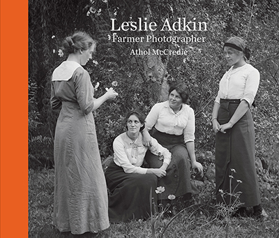 Balck and white photo of four women and the words Leslie Adkin Farmer Photographer Athol McCredie on the top middle