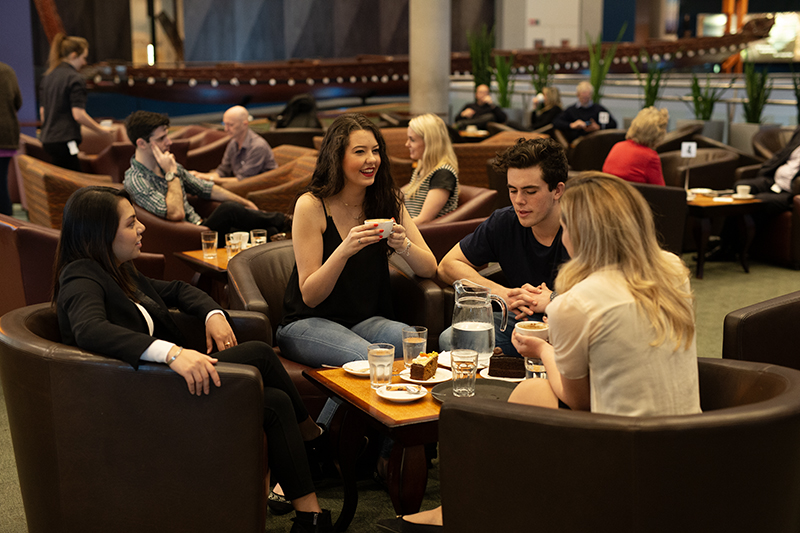 Several people sitting in a cafe.