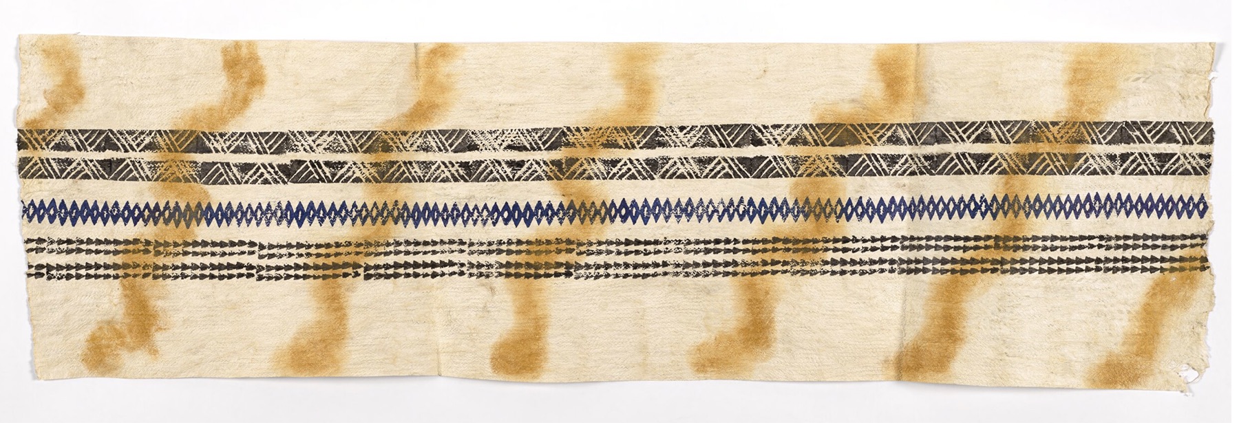 A long piece of bark cloth with repeating patterns printed on it.