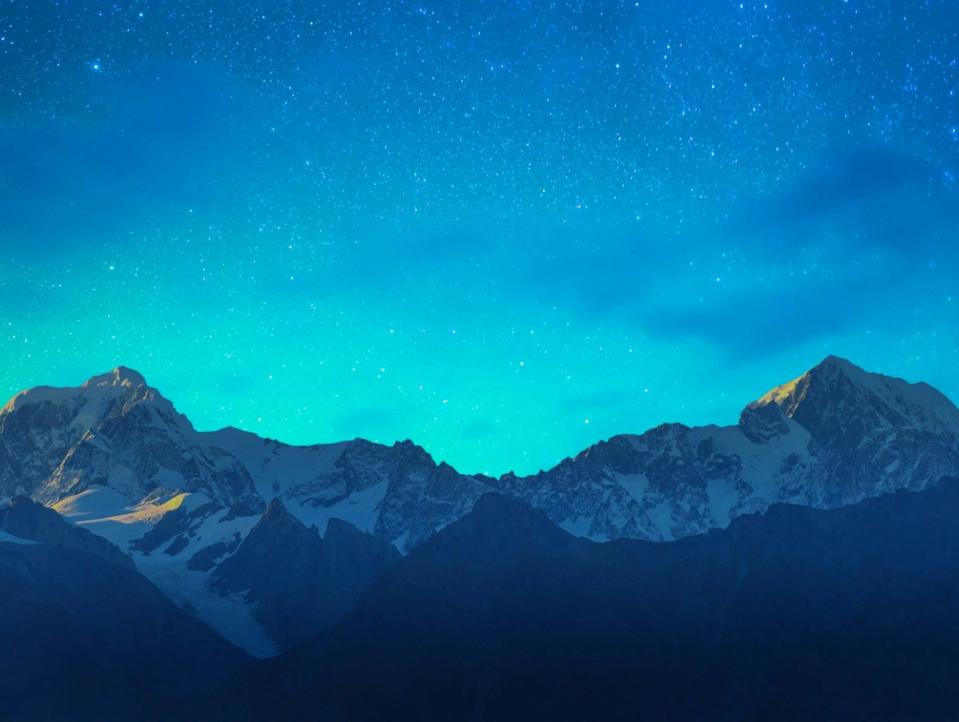 A view of snowy mountains at night.