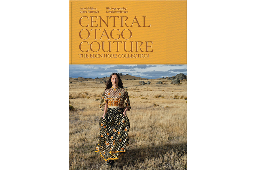 Book cover for Central Otago Couture with the authors, photographer and title in orange and a photo of a woman in a dress standing in a field.