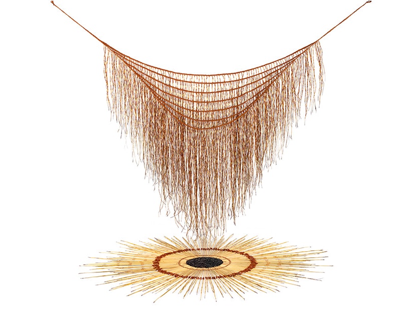 Maureen Lander, Huna: Kaitiaki o te Harakeke, 2012. Te Papa (ME024116) An art work with a woven harakeke (flax) cape is hanging over another woven artwork arranged in a circle on the white ground.