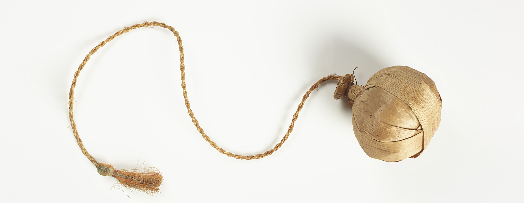 A ball made of raupo flax with a cord attached.