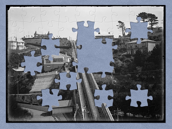 Kelburn Cable Tramway looking towards the summit, 7 March 1918, by Leslie Adkin. Gift of G. L. Adkin family estate, 1964. Te Papa (B.021054) Black and white photo with jigsaw-shaped pieces missing.