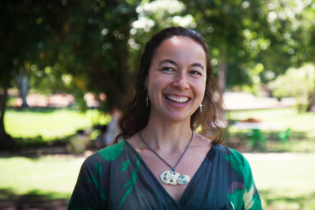 Still from a video of a woman talking and smiling. She is looking just off camera.