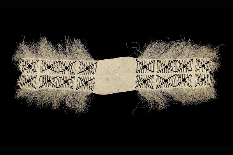 An intricately woven mat on a black background.
