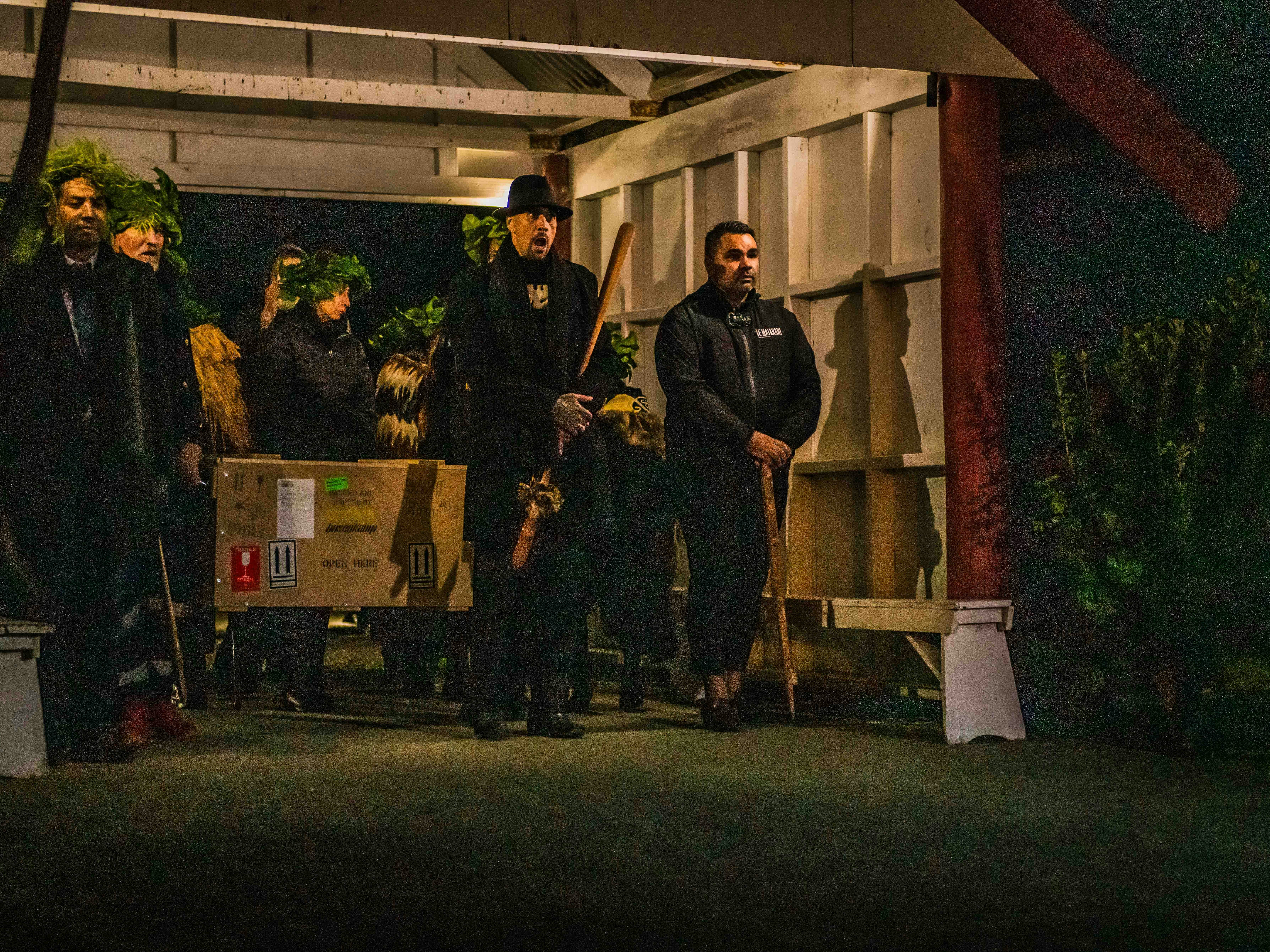 Members of Te Uri a Hau bringing their kōiwi into the marae setting