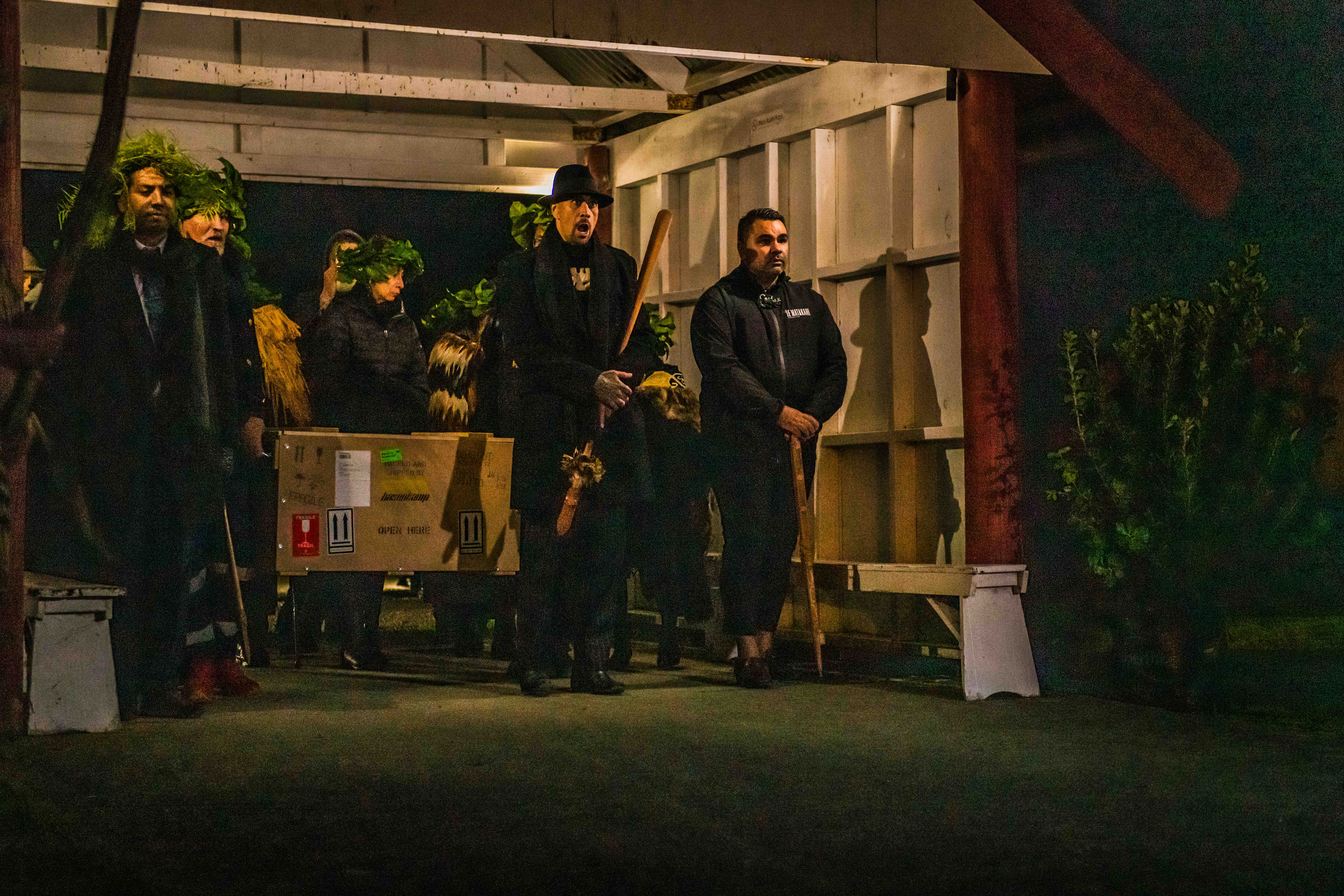 Members of Te Uri o Hau bringing their kōiwi into the marae setting