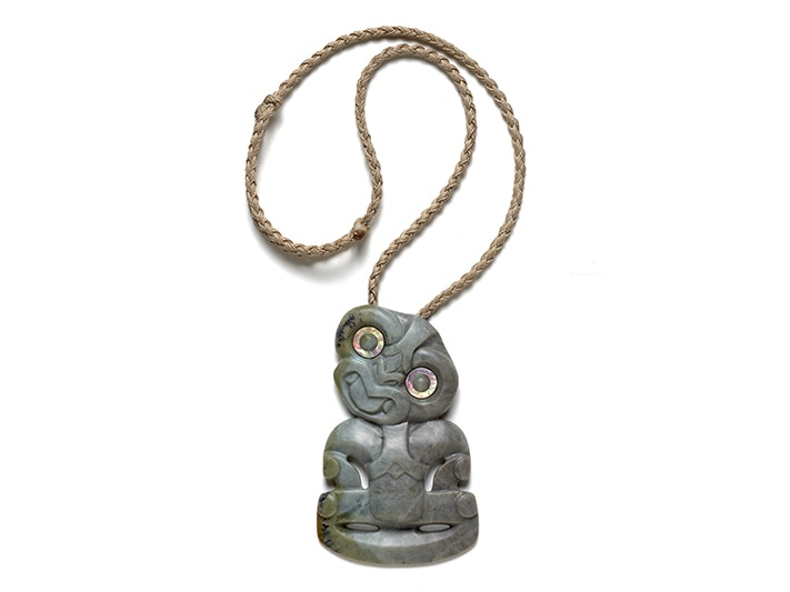 Hei Tiki by Tim Steel (Ngai Tahu) A pounamu or New Zealand Greenstone pendant in human form with a woven cord.