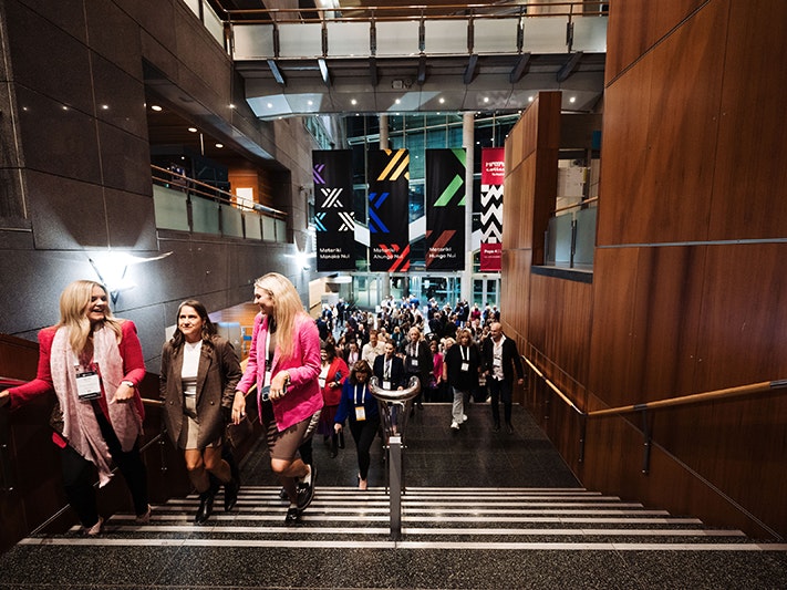 Meetings trade show, 2023. Photo by Smoke Photography. Te Papa (231488) A lot of people walking up the stairs at a museum at night.