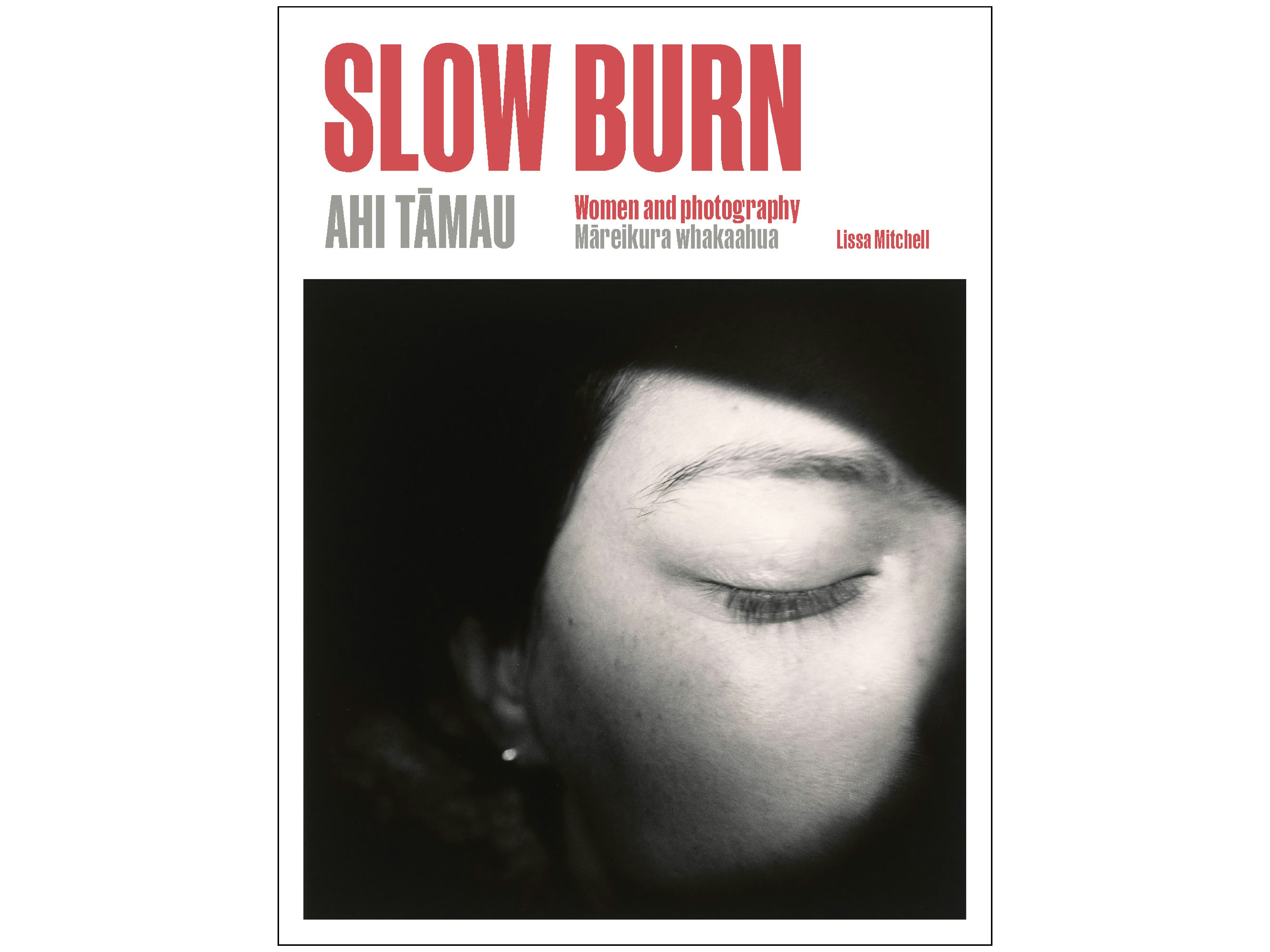 Cover of Slow Burn: Women and Photography A book cover with the title at the top in red, and a black and white photo of a close view of a person's closed eye and eyebrow.