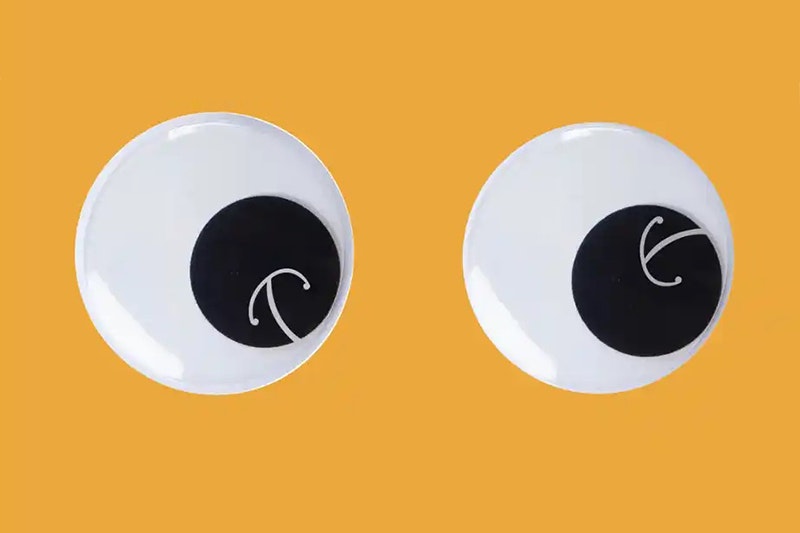 Two large googly eyes each with a white Māori koru design on the black pupil.