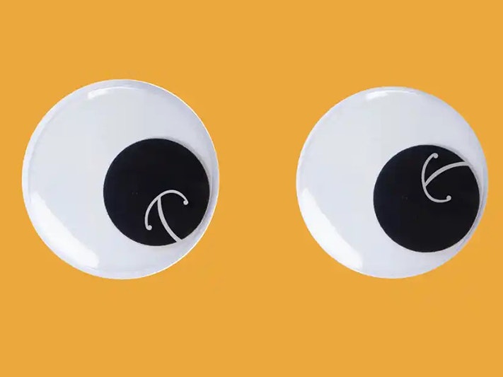 Illustration by Te Papa Two large googly eyes each with a white Māori koru design on the black pupil.