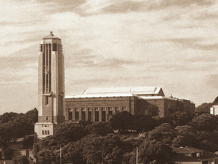 (Crop) Laurence Aberhart, Buckle Street Building from Taranaki Street Rooftop. Te Papa (O.002331) A sepia-toned photograph of a large building and a tall bell tower.